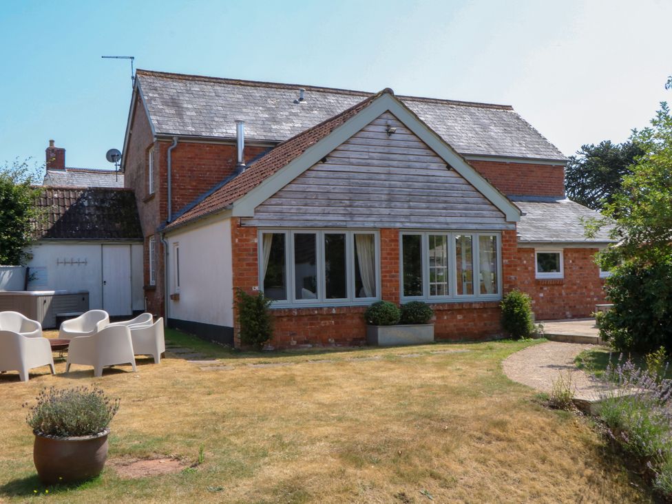 A house with a garden and patio chairs at Apple Mill in Venn Ottery near Sidmouth