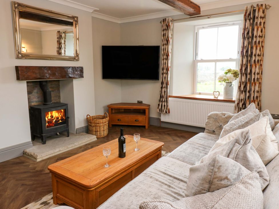 A living room with a sofa and coffee table at Eastfield Farm in Barnard Castle