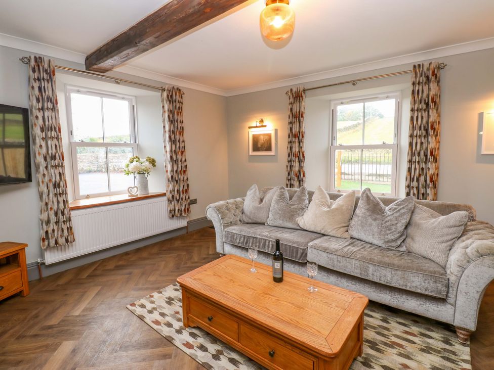 A living room with a sofa and coffee table at Eastfield Farm in Barnard Castle