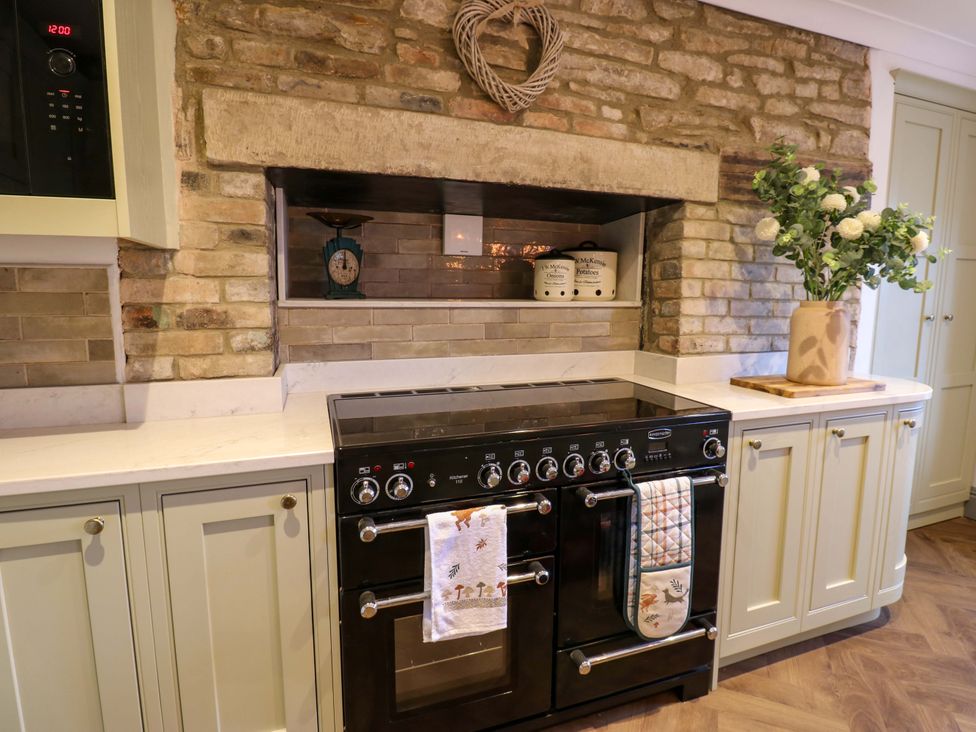 A kitchen with a stove and cabinets at Eastfield Farm in Barnard Castle