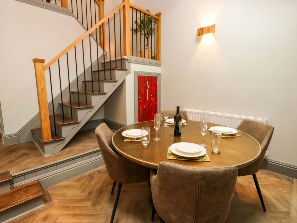 A dining room with a table set for dinner at Eastfield Farm in Barnard Castle