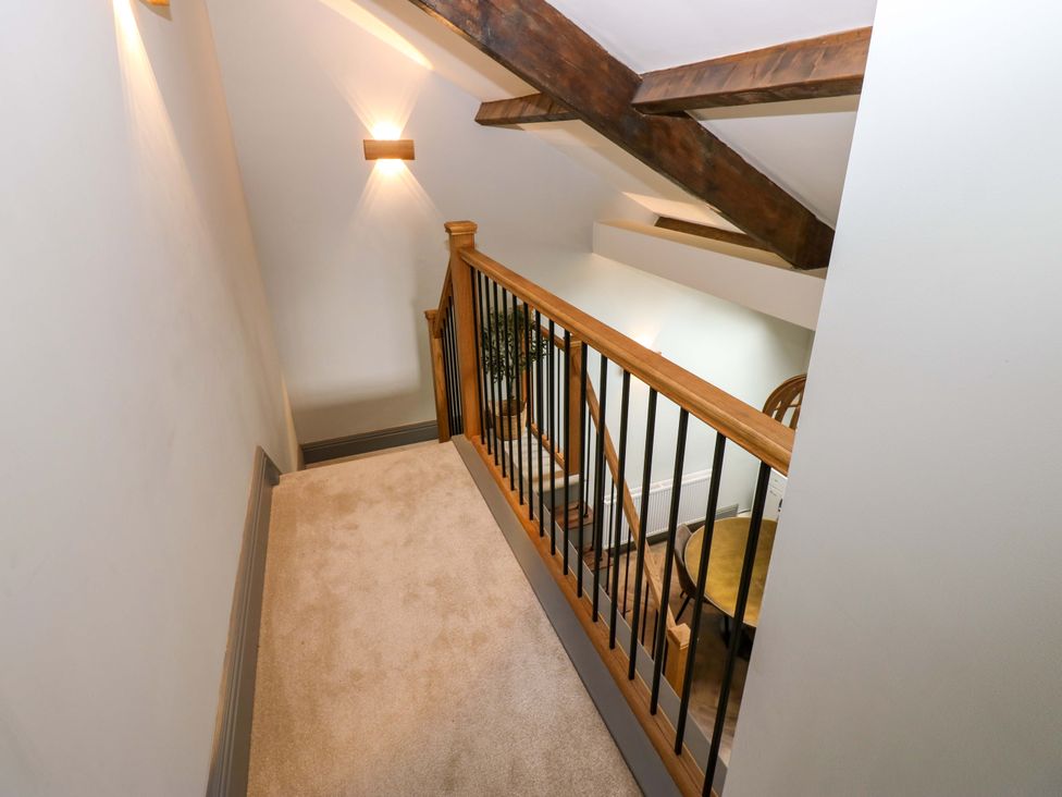 A hallway with a staircase and banister at Eastfield Farm in Barnard Castle
