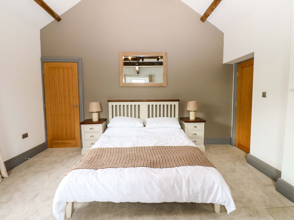 A bedroom with a bed and bedside tables at Eastfield Farm in Barnard Castle