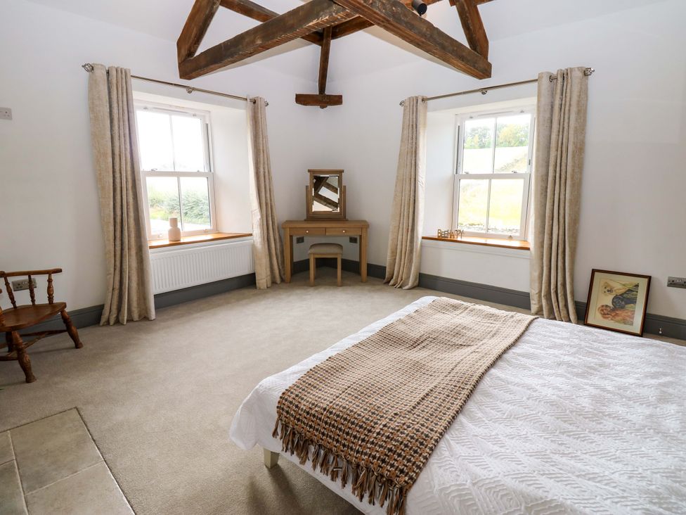 A bedroom with a bed and a table at Eastfield Farm in Barnard Castle
