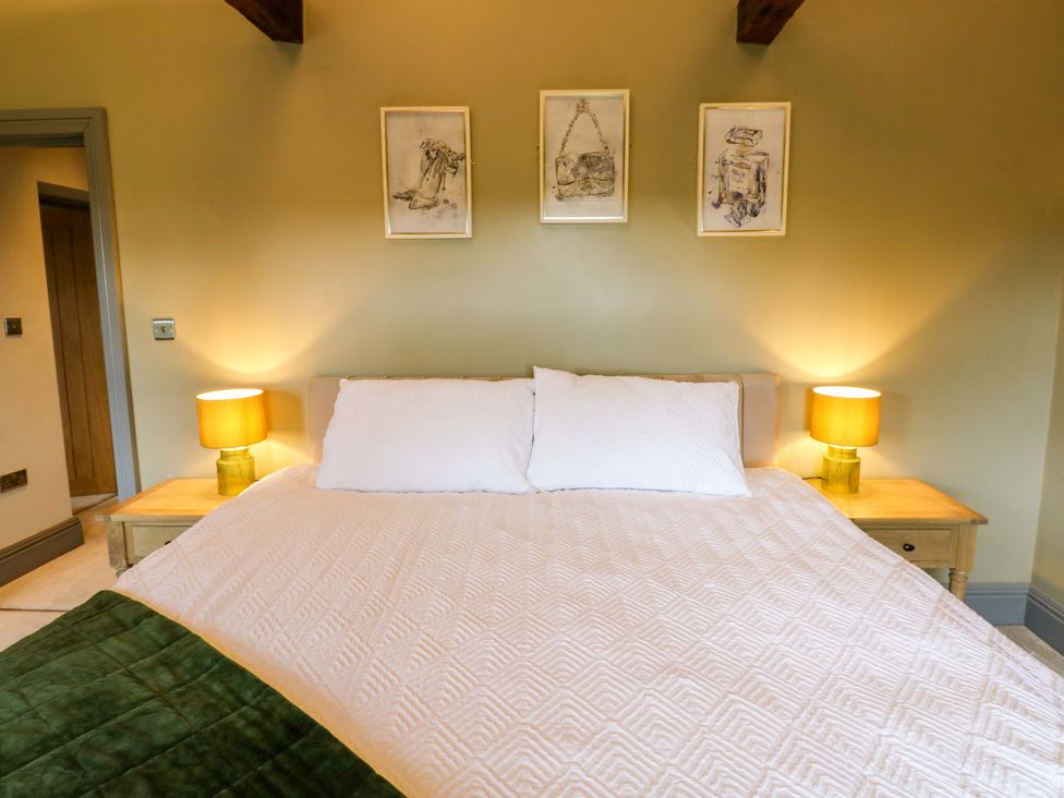 A bedroom with a bed and lamps at Eastfield Farm Barnard Castle