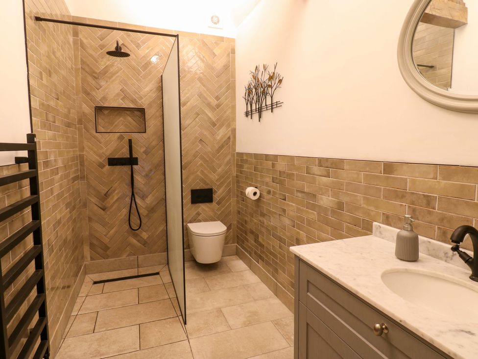 A bathroom with a shower, toilet, and sink at Eastfield Farm in Barnard Castle