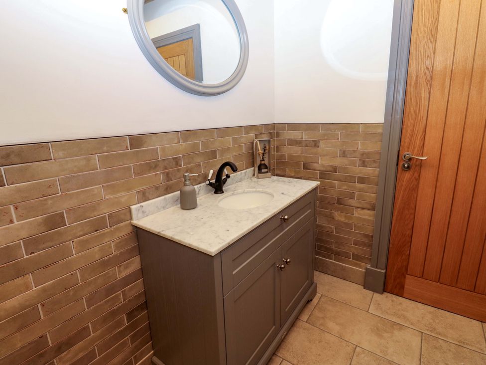 A bathroom with a sink and mirror at Eastfield Farm in Barnard Castle