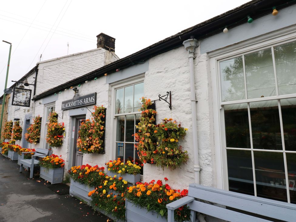 A building with a sign and flowers at Blacksmiths Arms in Barnard Castle