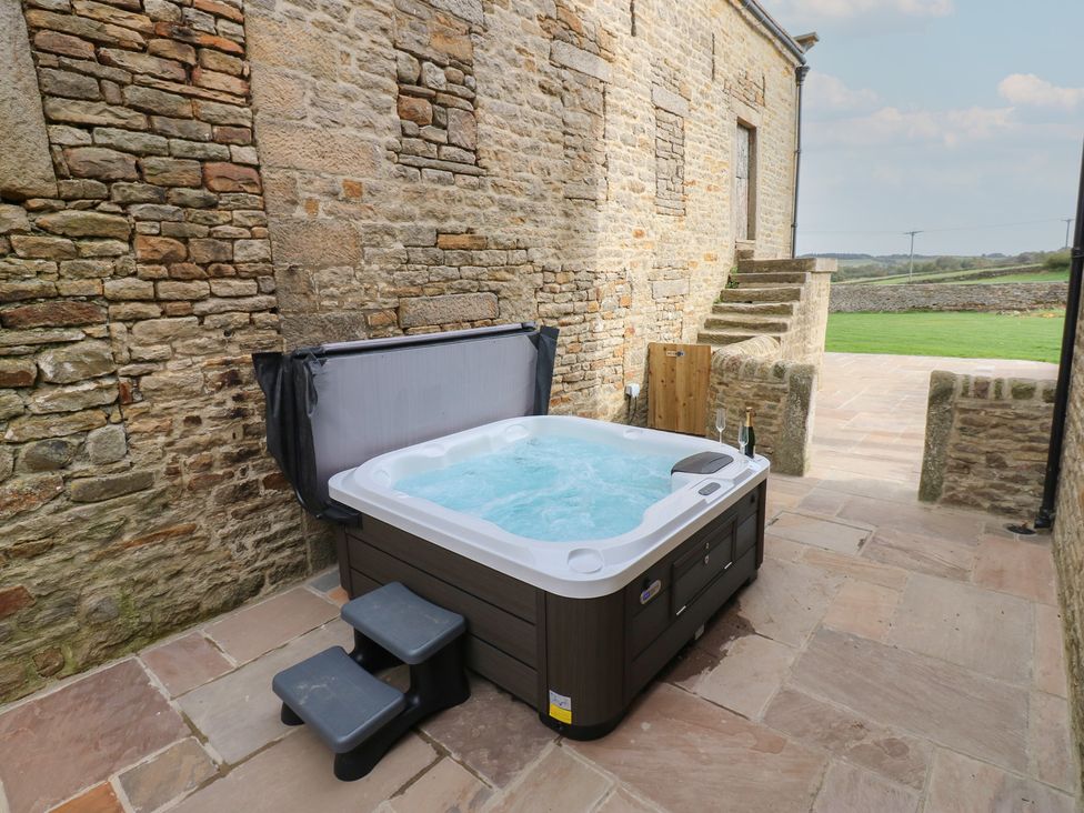 An outdoor area with a hot tub and steps at Eastfield Farm in Mickleton, Teesdale