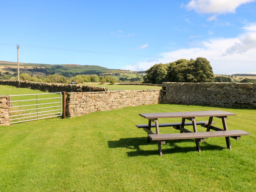 A picnic table near a stone wall at Eastfield Farm in Mickleton, Teesdale