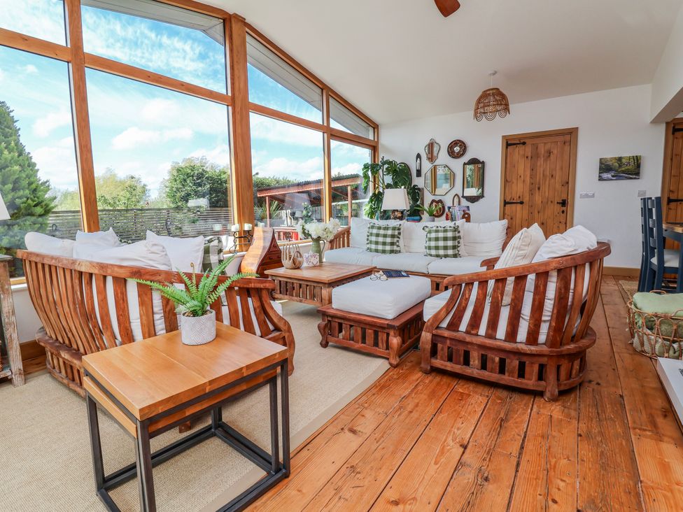 A living room with a sofa and chairs at Burlodge Swimbridge near Barnstaple