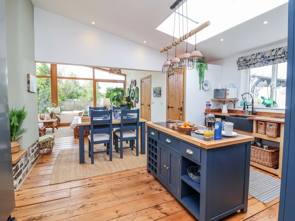 A kitchen with a dining table and chairs at Burlodge, Swimbridge near Barnstaple
