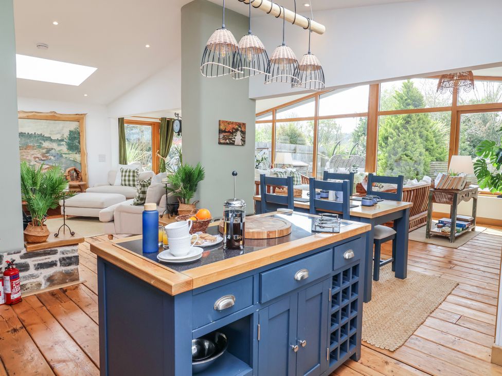 A kitchen with an island and seating at Burlodge in Swimbridge near Barnstaple