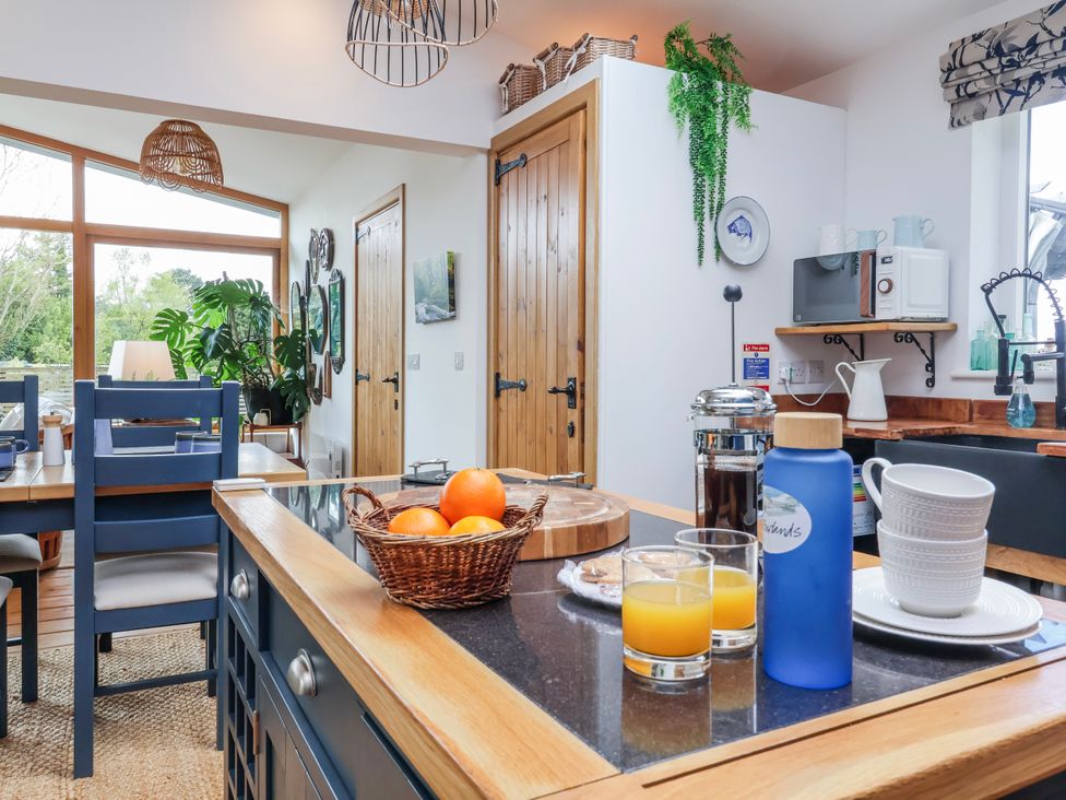 A kitchen with a table and chairs in Burlodge Swimbridge near Barnstaple