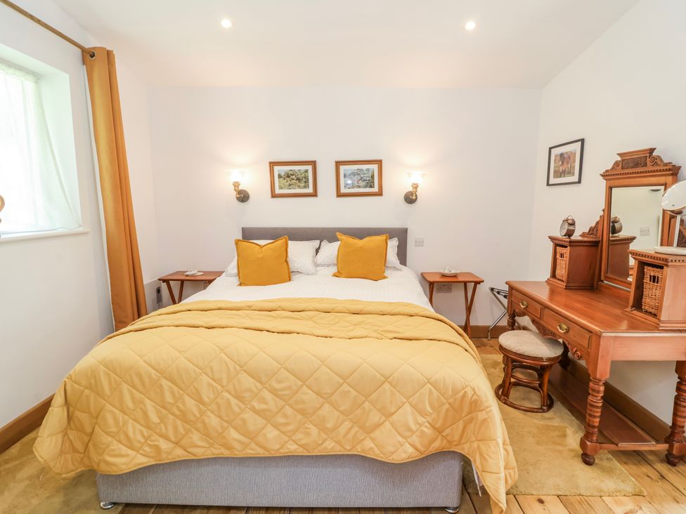 A bedroom with a bed and dressing table at Burlodge Swimbridge near Barnstaple