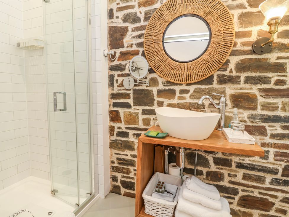 A bathroom with a shower and sink at Burlodge Swimbridge near Barnstaple