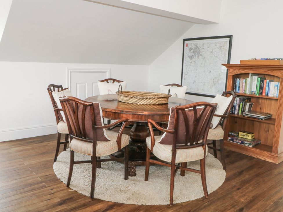 A dining area with a round table and chairs at Poplar Farm Studio in Hatton Heath near Aldford