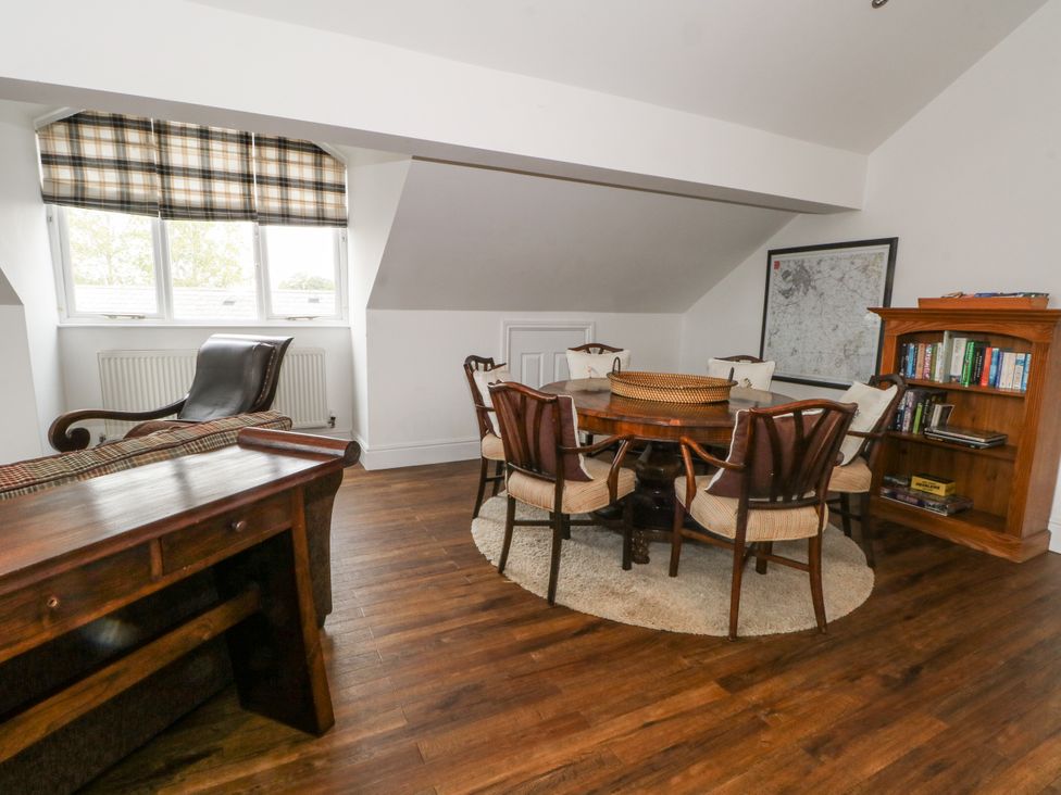 An office with a desk, table, chairs and bookshelf at Poplar Farm Studio in Hatton Heath near Aldford