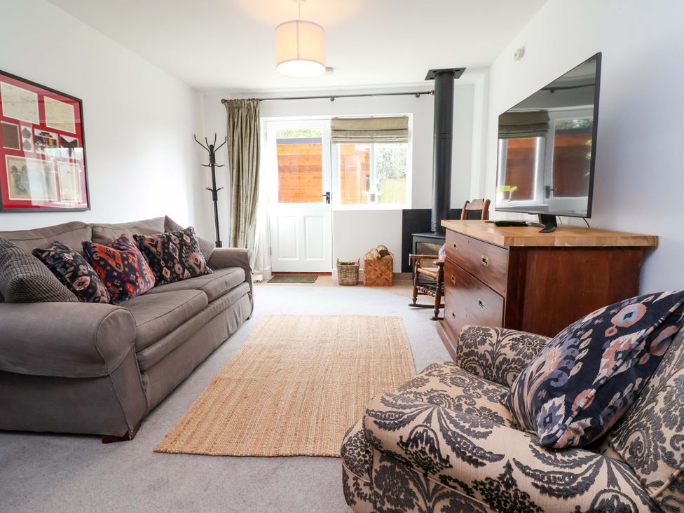 A living room with a sofa and television at Poplar Farm Studio in Hatton Heath near Aldford