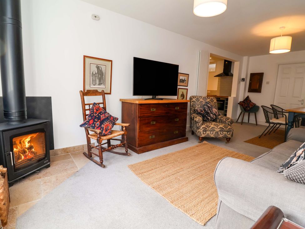 A living room with a fireplace and television at Poplar Farm Studio, Hatton Heath near Aldford
