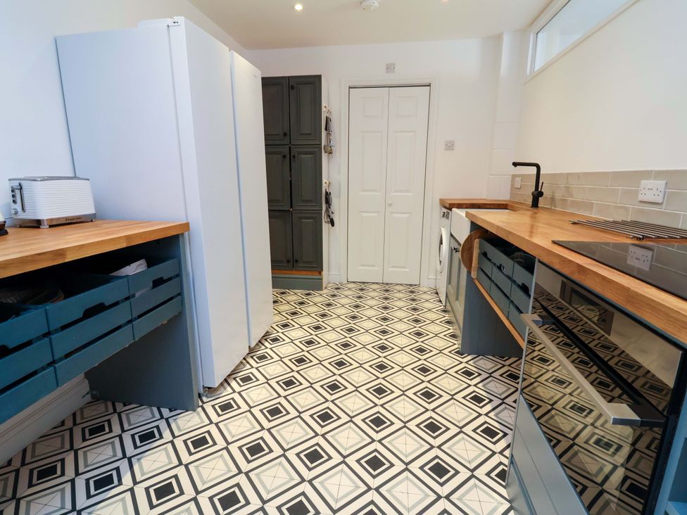 A kitchen with refrigerator, cabinets, and countertop at Poplar Farm Studio Hatton Heath near Aldford