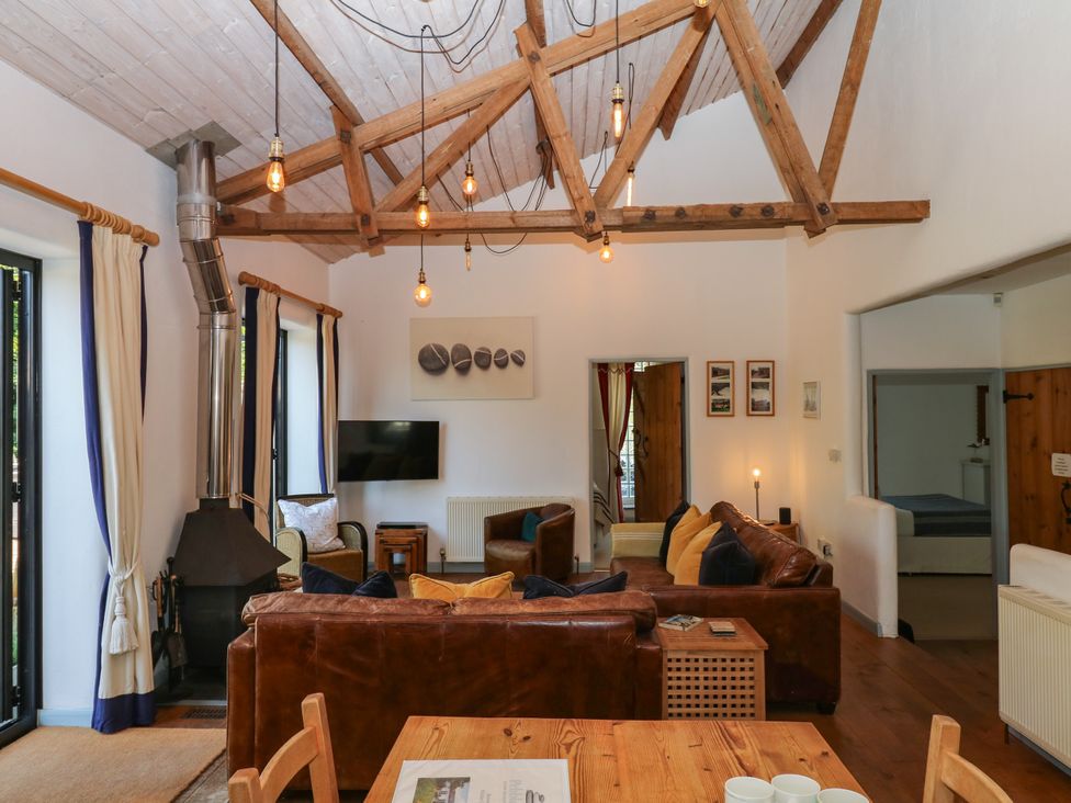 A living room with a sofa and television at Burrows in Venn Ottery near Sidmouth