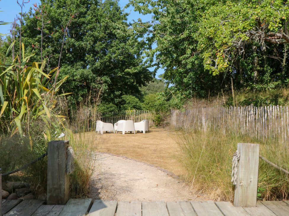 A garden with chairs and a pathway at Burrows in Venn Ottery near Sidmouth