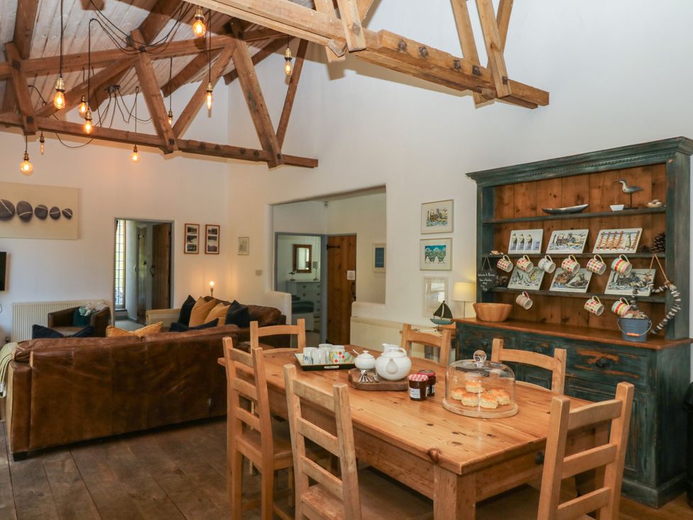 A living room with a dining table and chairs at Burrows Venn Ottery near Sidmouth