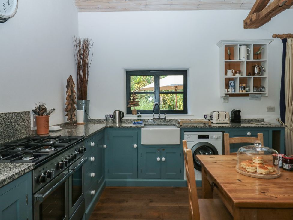 A kitchen with a sink and appliances at Burrows in Venn Ottery near Sidmouth