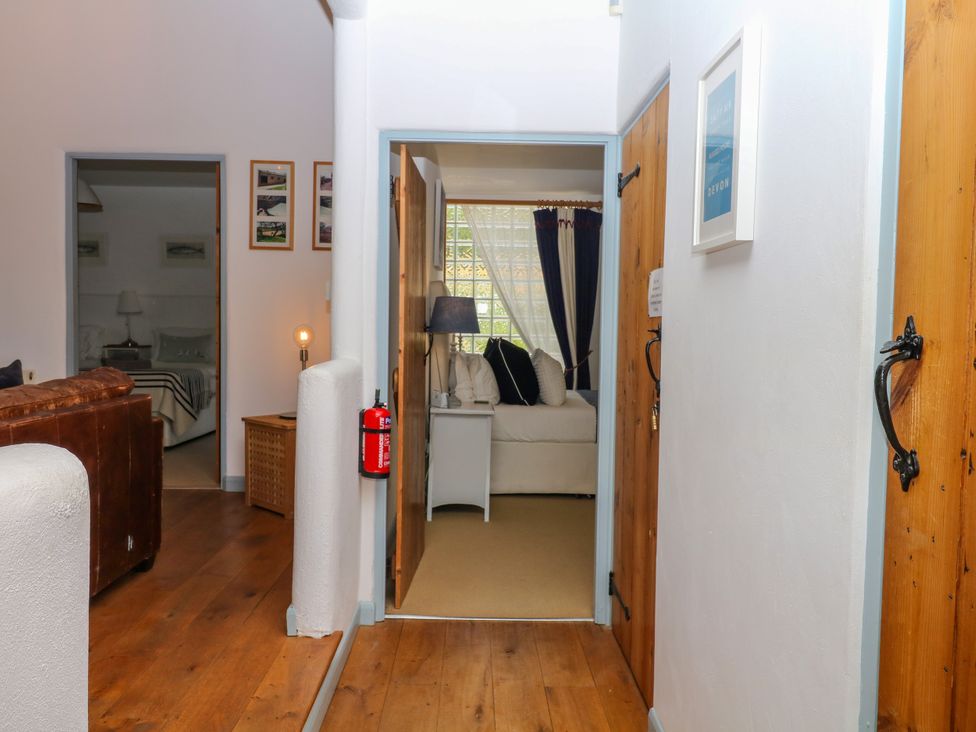 A hallway with a sofa and lamp at Burrows Venn Ottery near Sidmouth