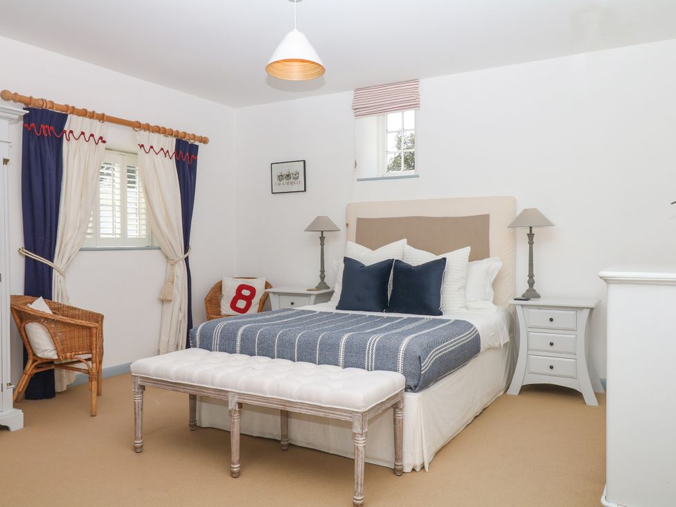 A bedroom with a bed and bedside tables at Burrows in Venn Ottery near Sidmouth