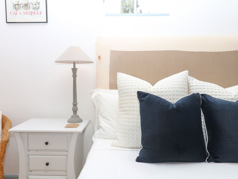 A bedroom with a bed and nightstand at Burrows Venn Ottery near Sidmouth