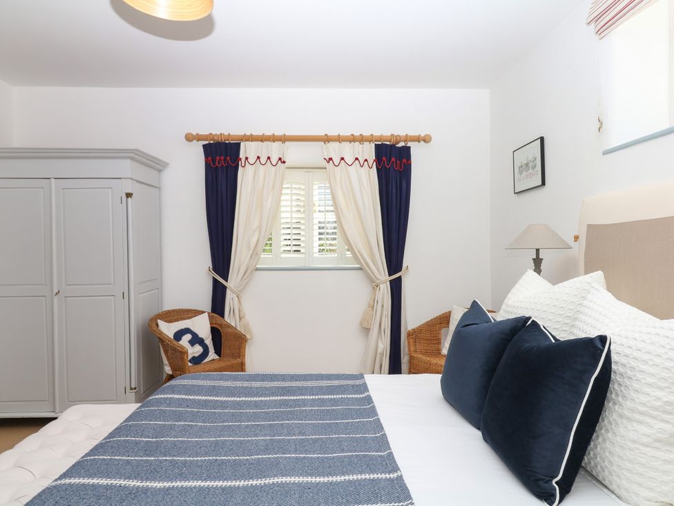 A bedroom with a bed and wardrobe at Burrows Venn Ottery near Sidmouth