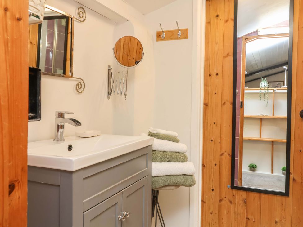 A bathroom with a sink and towels at Sunset Cottage Swimbridge near Barnstaple