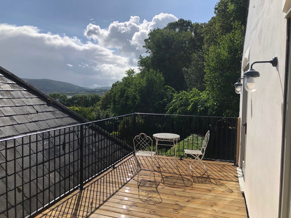 A balcony with a table and chairs at Worthy Barn in Porlock Weir