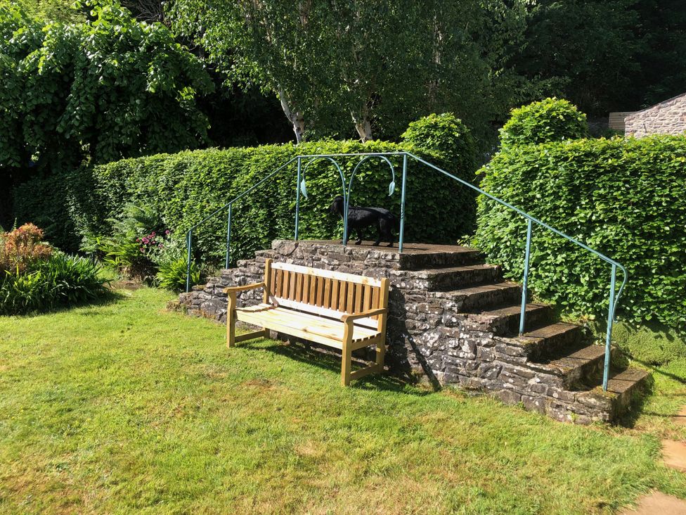 A bench and steps in a garden at Worthy Barn Porlock Weir