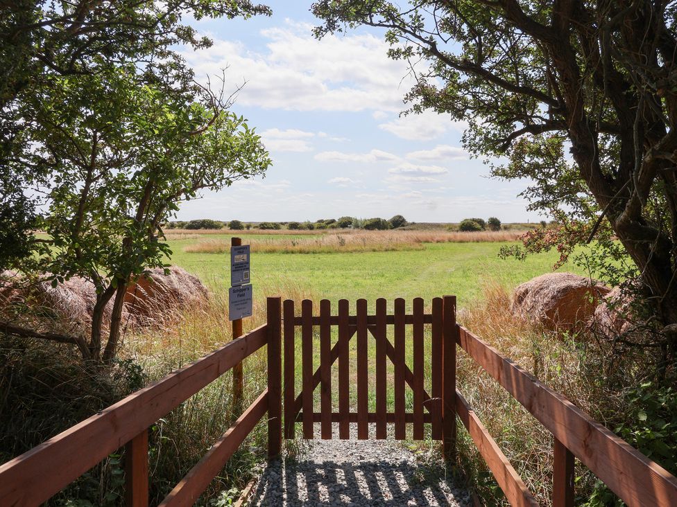 A gate leading to a grassy field at Waverley Cottage in Kilnsea near Easington, Hull