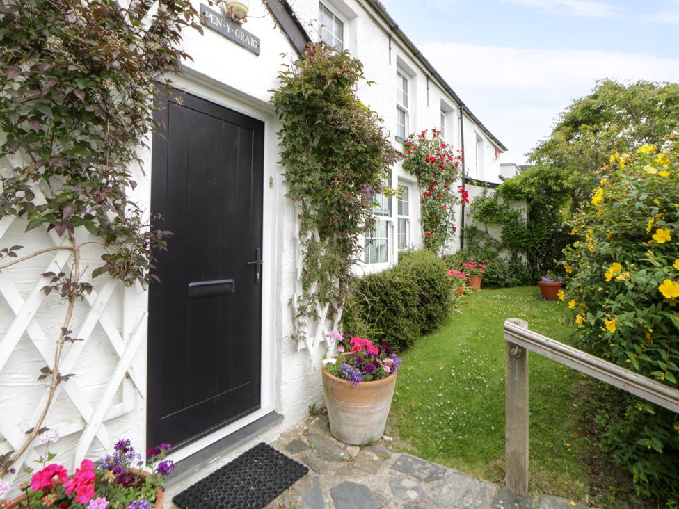 An entrance doorway with flower pots and plants at Pen y Graig in Aberporth