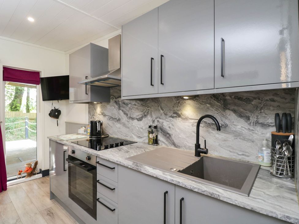 A kitchen with modern appliances and countertop at Squirrels Lodge in South Molton