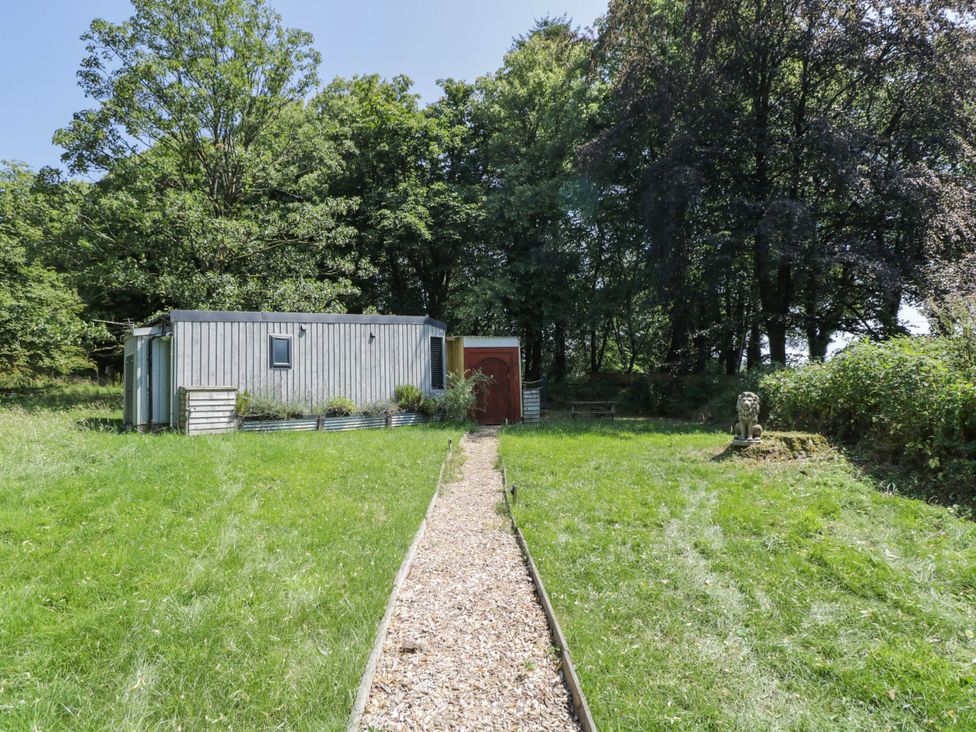 An outdoor view of a building with a pathway at Squirrels Lodge in South Molton