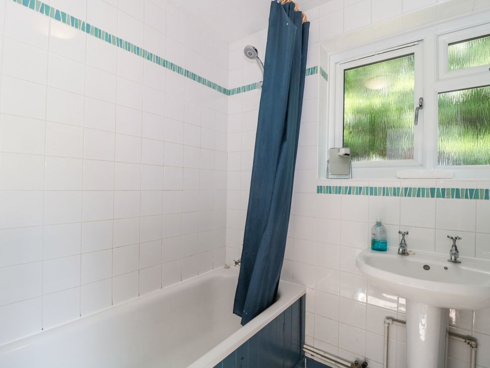 A bathroom with a bathtub and a sink at Stones Throw in Lymington