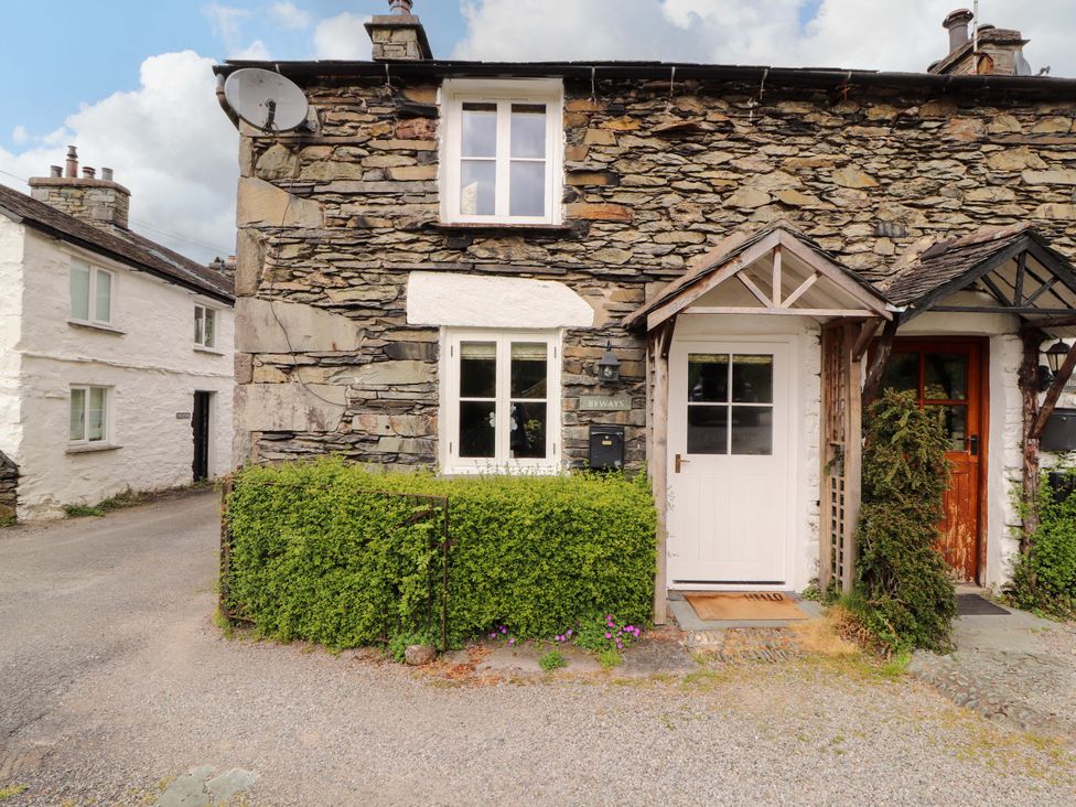 An outdoor view of a stone house with a front door and window at Byways Ambleside