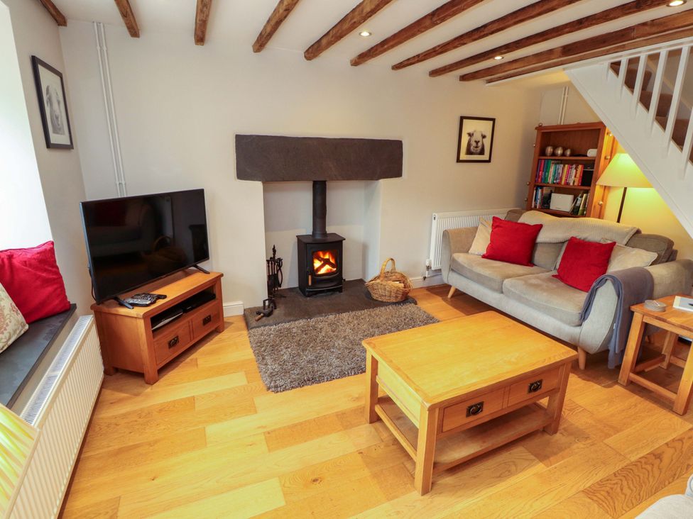 A living room with a fireplace and sofa at Byways in Ambleside