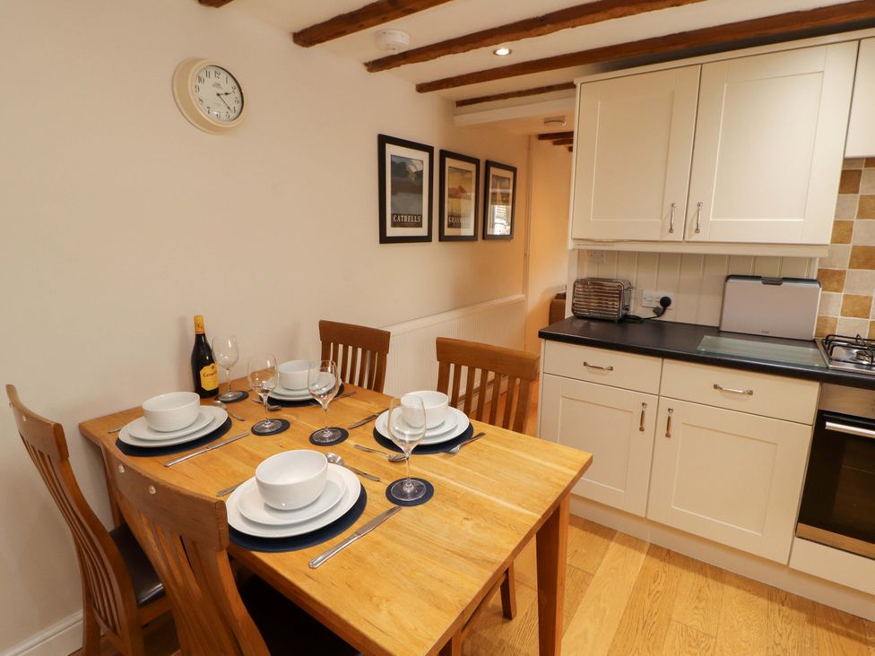 A dining room with a table set for meals at Byways Ambleside