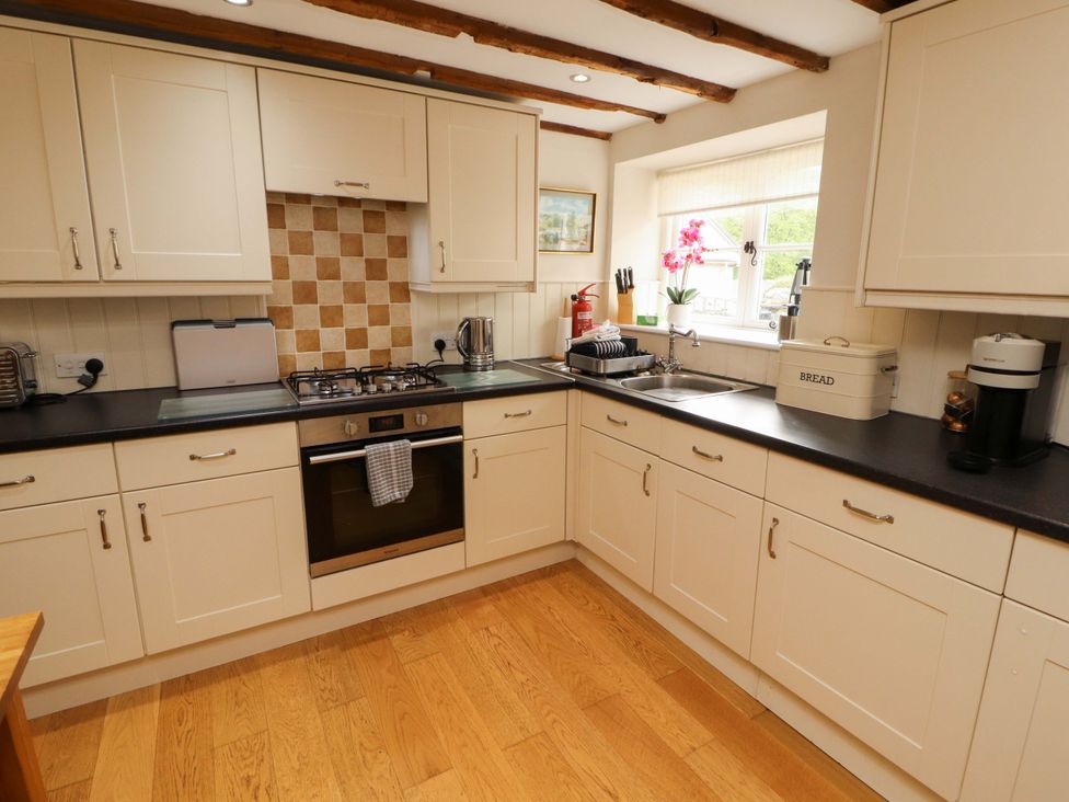 A kitchen with cabinets, countertop, sink and appliances at Byways Ambleside
