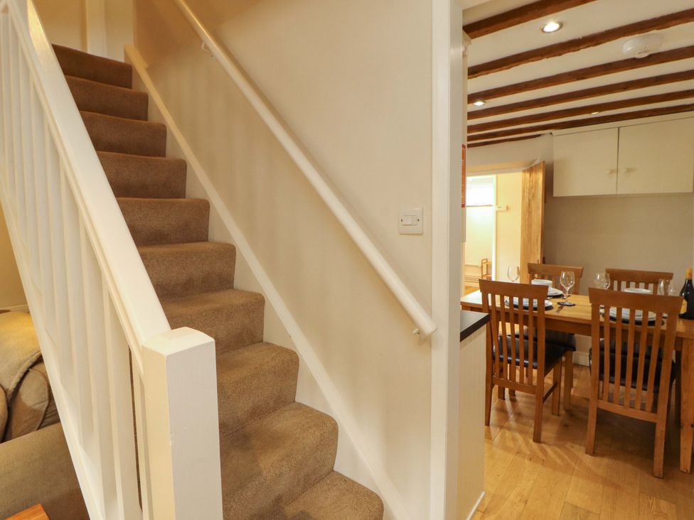 A staircase leading to upper level beside a dining area at Byways Ambleside