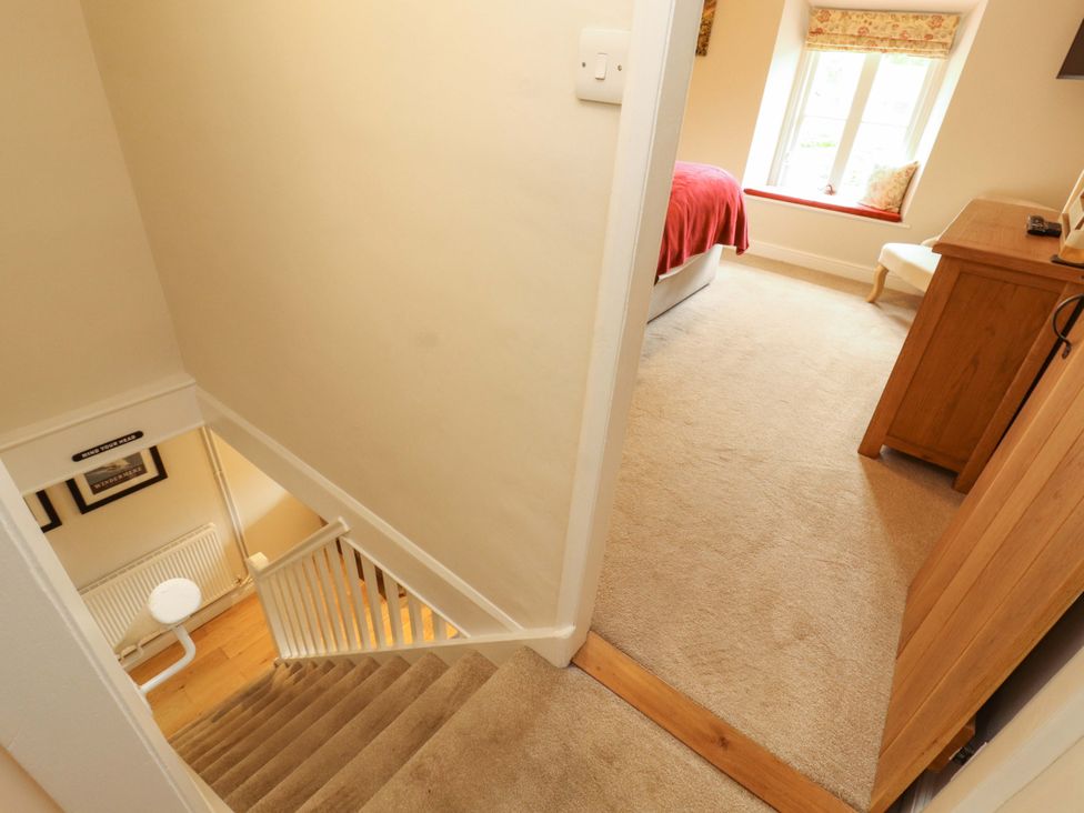 A hallway with a staircase and a bedroom view at Byways Ambleside