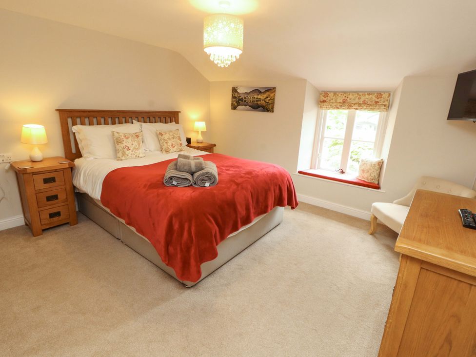 A bedroom with a bed and side tables at Byways in Ambleside