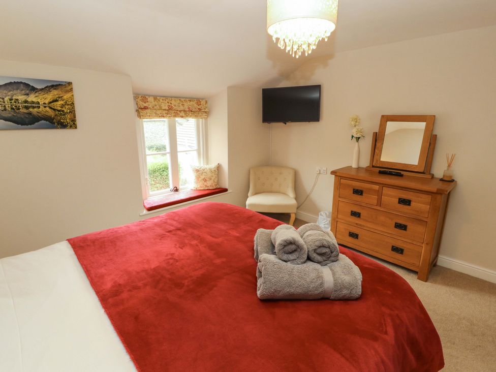 A bedroom with a bed and towels at Byways in Ambleside