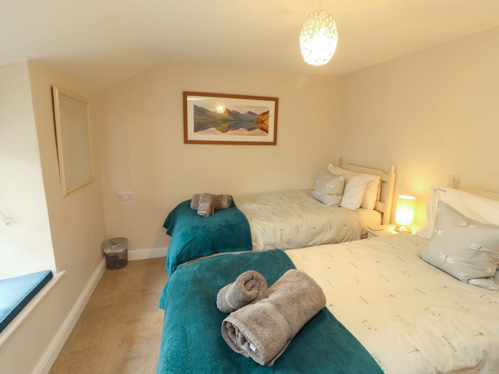 A bedroom with two beds and a painting at Byways in Ambleside